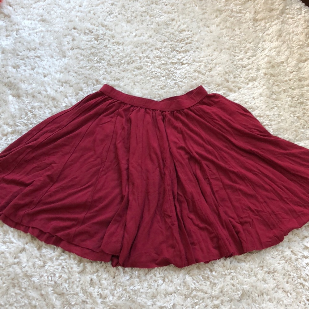 Red flowing pleated skirt.